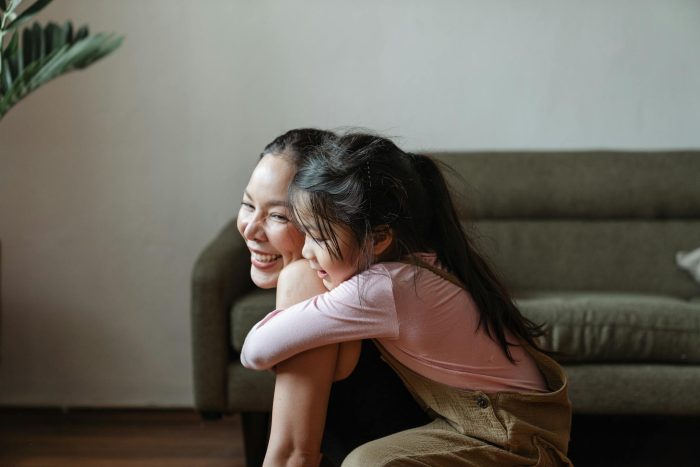 Photo of Girl Hugging Her Mom